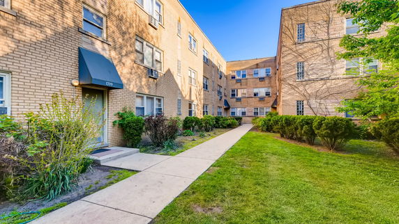 Front view of a multi-story brick apartment building.