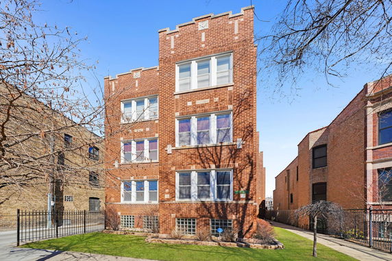 Front view of a multi-story brick apartment building.
