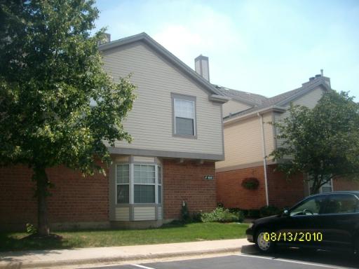 Front view of a house with a two-story design and brick lower facade.