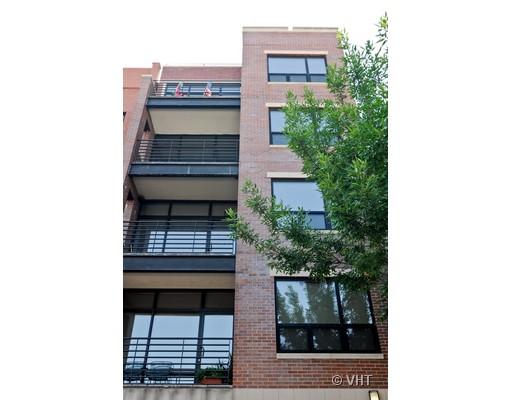 Front view of a multi-story brick building with balconies.