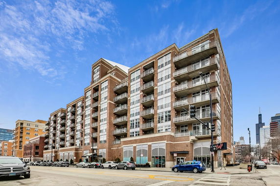 Front view of a multi-story residential building with balconies.