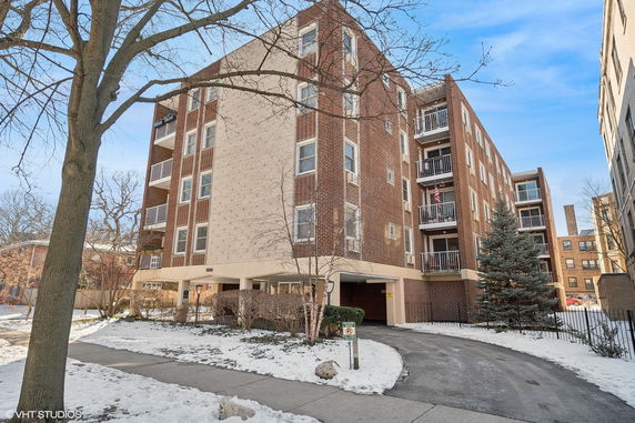 Front view of a multi-story brick building with balconies.