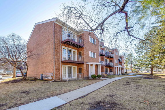 Front view of a multi-story brick residential building.