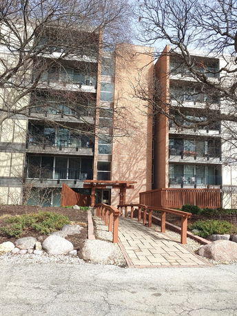 Front view of a multi-story apartment building with balconies.