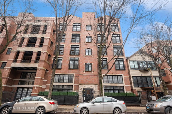 Front view of a multi-story brick apartment building.