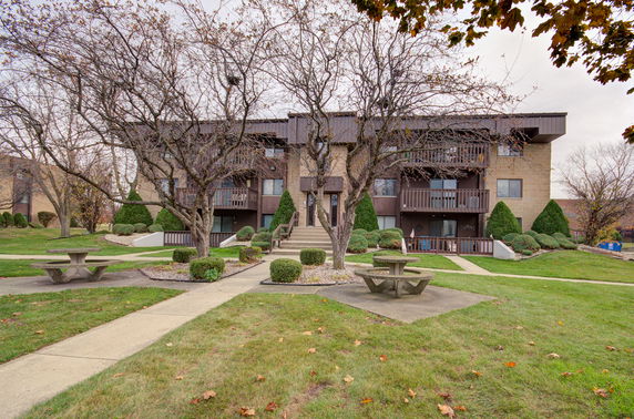 Front view of a multi-story residential building with balconies.