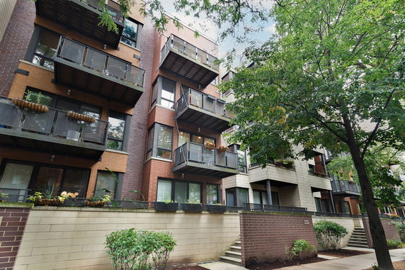 Front view of a multi-story apartment building with balconies.
