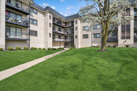 Front view of a multi-story residential building with balconies.