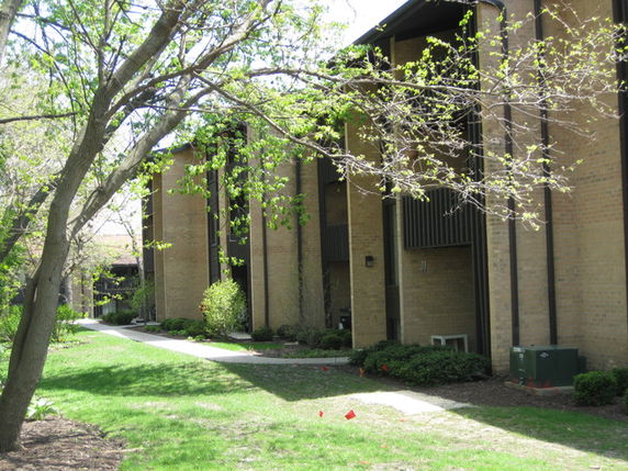 Side view of a brick building with balconies.