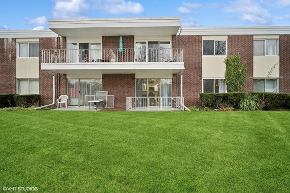 Front view of a two-story brick building with balconies.
