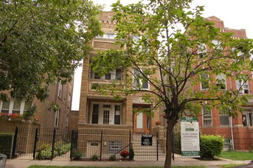 Front view of a multi-story brick apartment building.