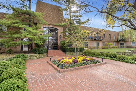 Front view of a two-story brick building with a large entrance.
