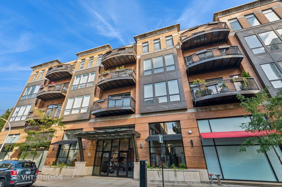 Front view of a multi-story building with balconies.