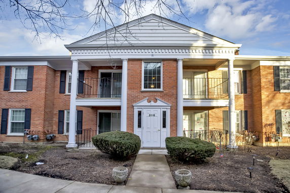 Front view of a two-story brick building with large white columns.