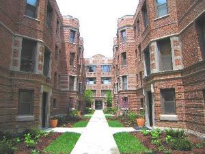 Front view of a multi-story brick apartment building.