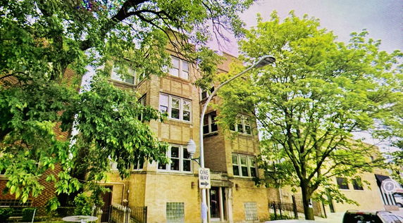 Front view of a multi-story brick building.
