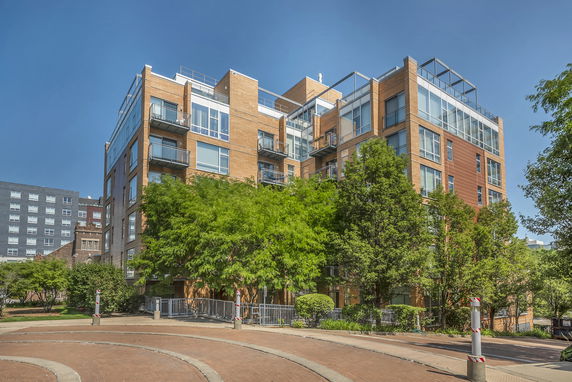 Front view of a contemporary multi-story apartment building with balconies.