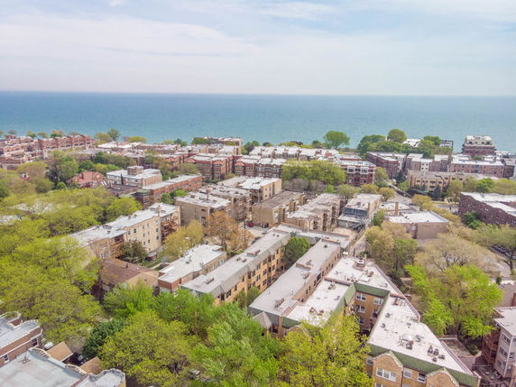 Aerial view of a residential area near a large body of water.