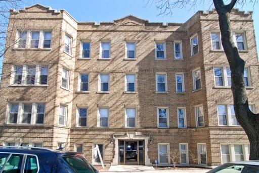 Front view of a multi-story brick apartment building.