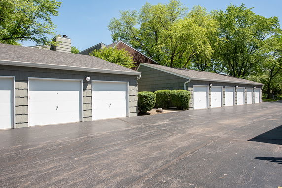Outdoor parking area with multiple garages.