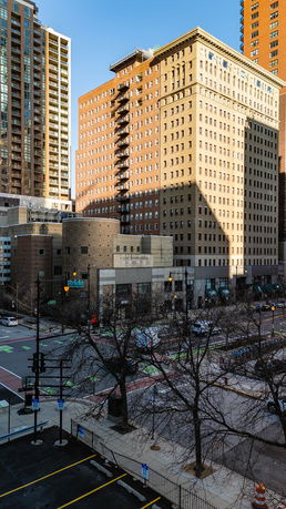 Front view of a multi-story building in a city setting.