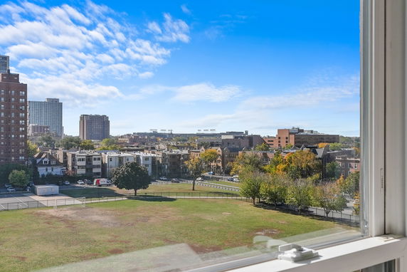 Panoramic view of a cityscape seen from a building window.