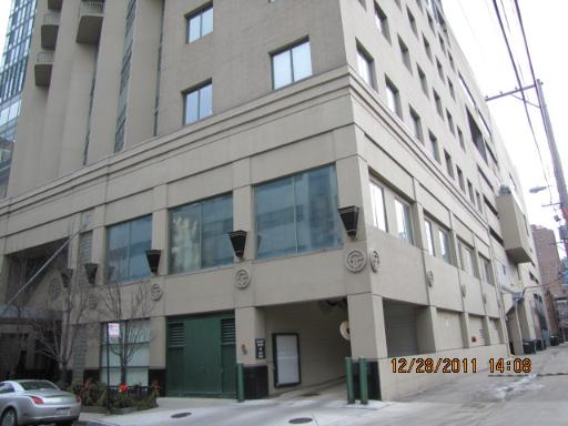 Front view of a multi-story building with large windows and decorative elements.