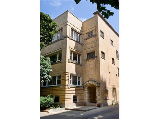 Front view of a multi-story brick building with multiple windows.