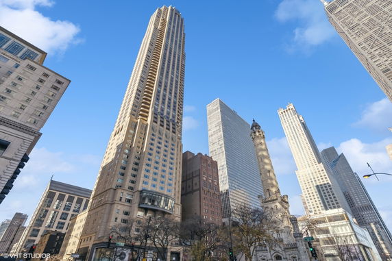 View of tall skyscrapers and historic buildings in a city skyline.