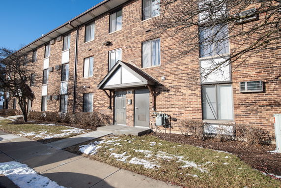 Front view of a three-story brick apartment building.