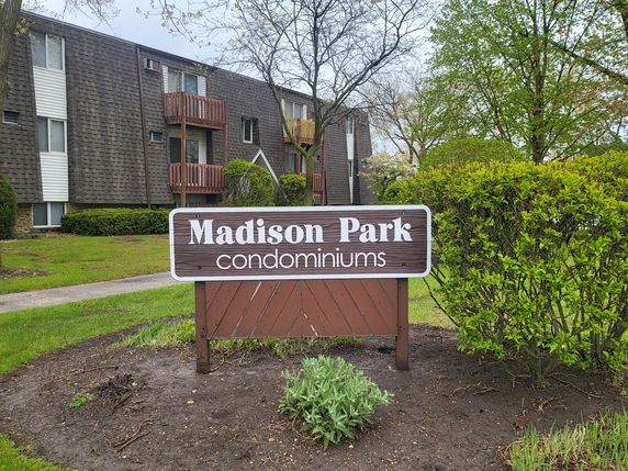 Front view of a condominium complex with multiple stories and balconies.