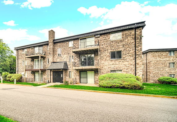Front view of a multi-story brick apartment building.