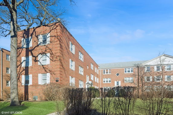 Front view of a multi-story brick apartment building.