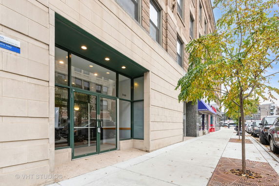 Front view of a commercial building entrance with glass doors.