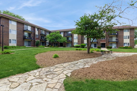 Front view of a three-story apartment building with balconies.