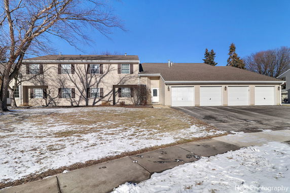 Front view of a two-story house with an attached multi-car garage.