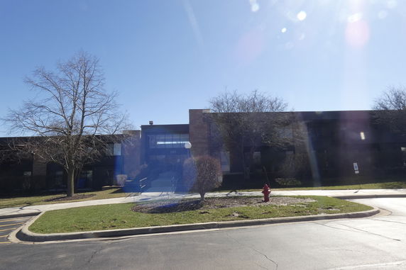 Front view of a two-story building with large windows and a central entrance.