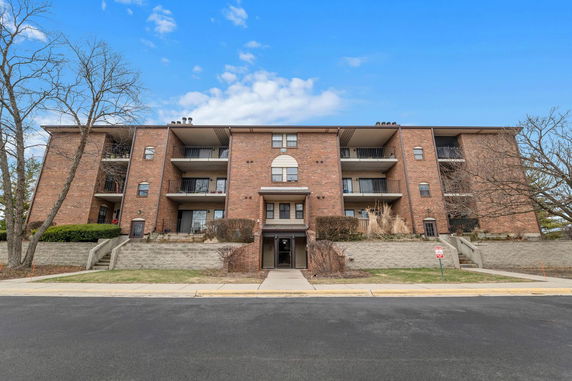 Front view of a multi-story brick apartment building.