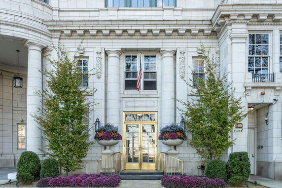 Front view of a building with classical architectural features and entrance flanked by columns.