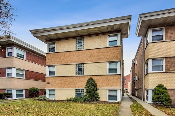 Front view of a three-story brick apartment building