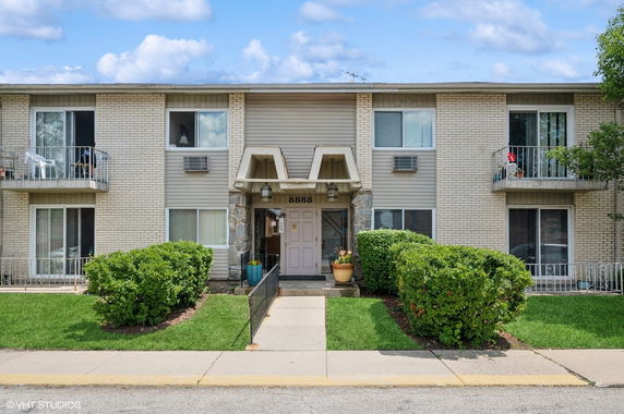 Front view of a two-story residential building with balconies.