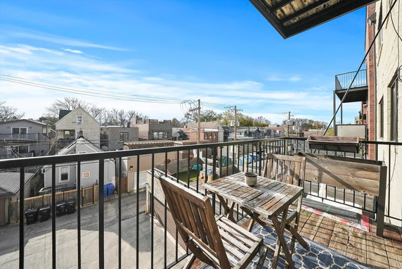 View from a balcony overlooking residential buildings and streets.