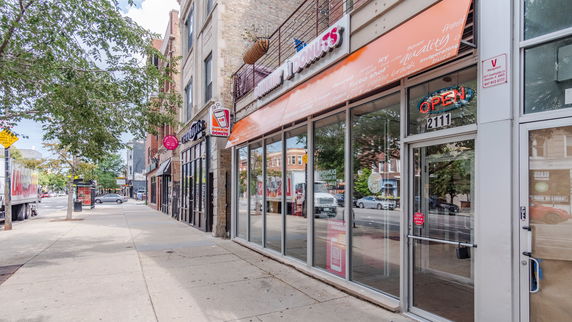 Front view of a commercial building with a Dunkin' Donuts shop.