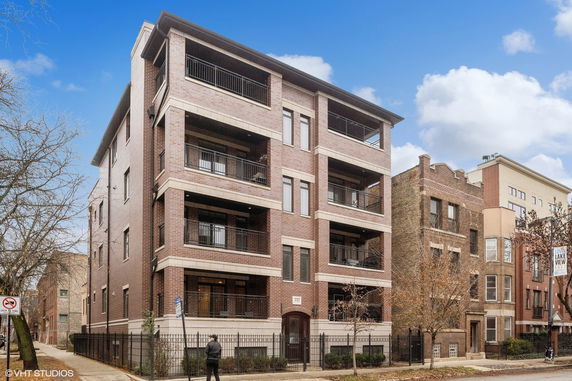 Front view of a multi-story brick apartment building.