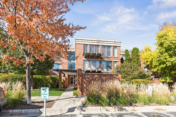 Front view of a multi-story brick building with balconies.