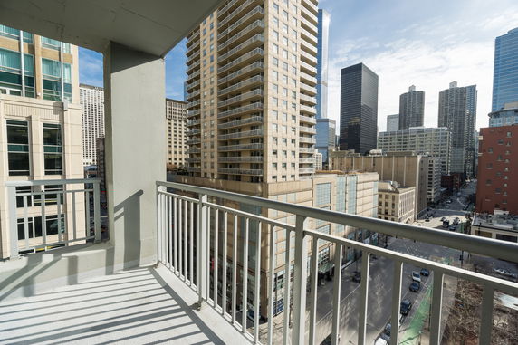 Panoramic view of city skyscrapers from a building balcony.
