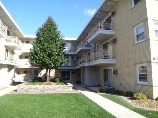 View of a multi-story apartment building with balconies.
