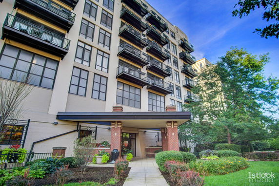 Front view of a multi-story residential building with balconies.