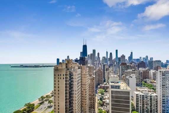 Panoramic view of a city skyline by a large body of water.