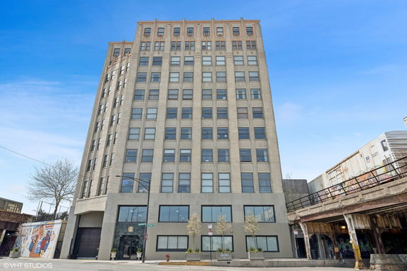 Front view of a multi-story building with numerous windows.